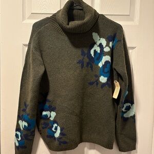 Woman’s olive green floral sweater